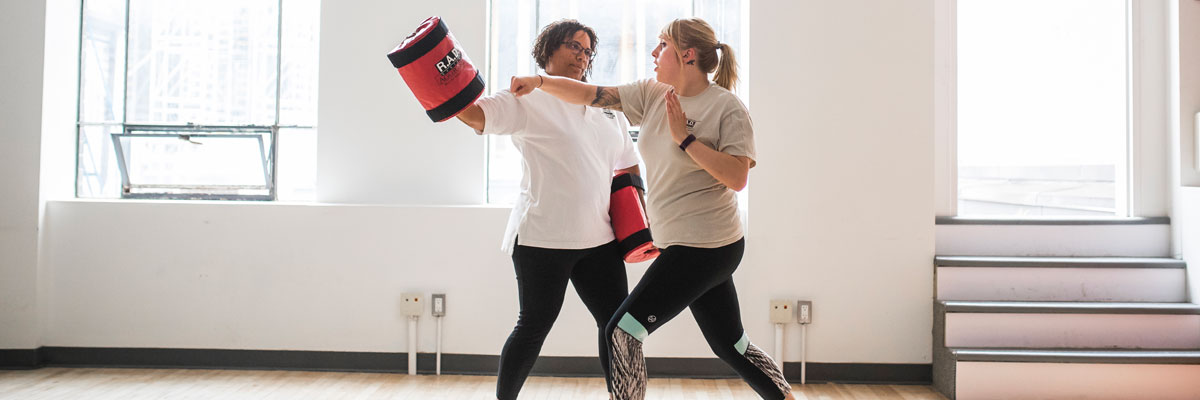 Two women practicing self-defence. 