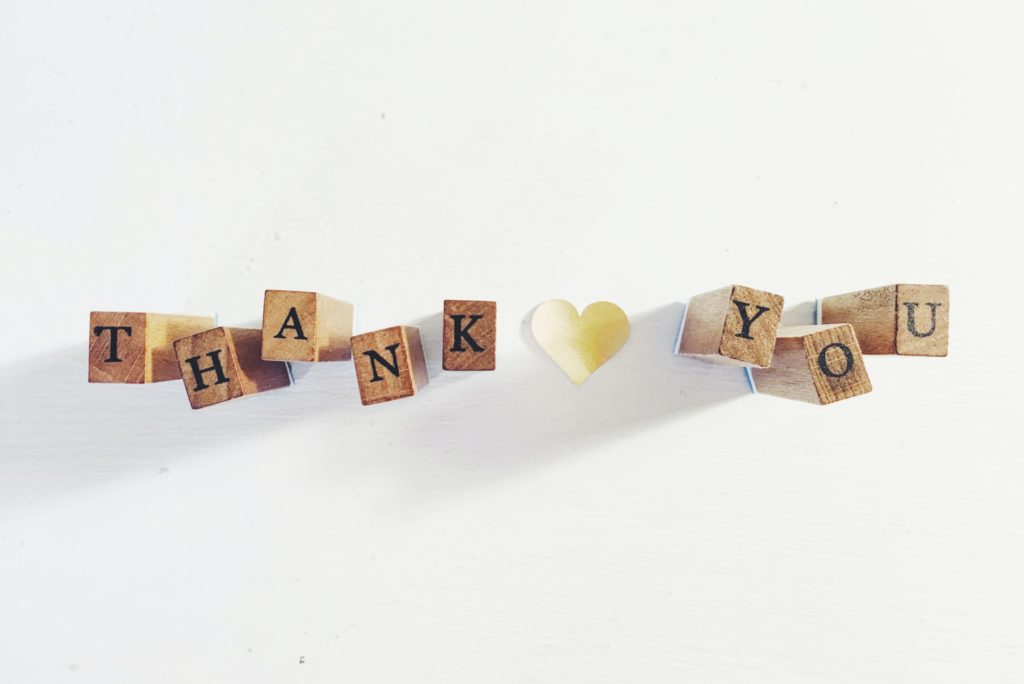 Small wooden cubes that spell out "Thank You"