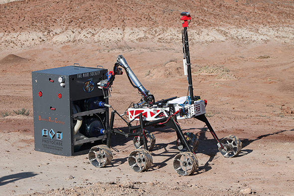 A robotic rover designed by Toronto MetRobotics on desert-like terrain.