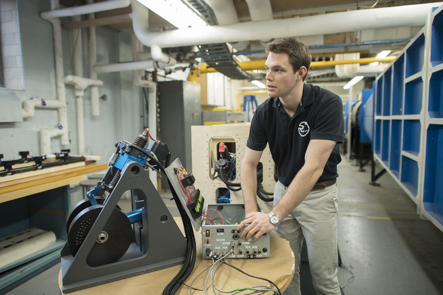 A student member of the TMU International Hyperloop Team working in a research lab