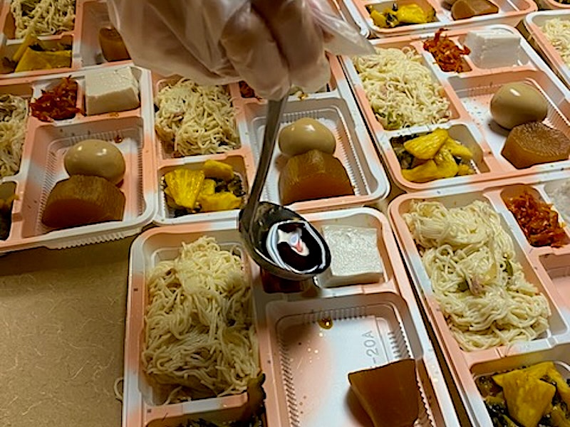 Food is being served in bento boxes at a Japanese congregate dining room in Toronto 