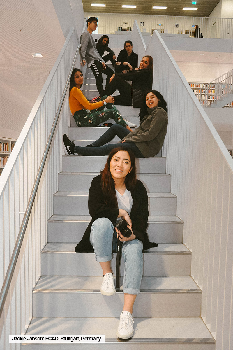 Toronto Metropolitan University FCAD student, Jackie Jabson, poses on a stairwell with friends during trendwatching short-term intensive course in Stuttgart, Germany.