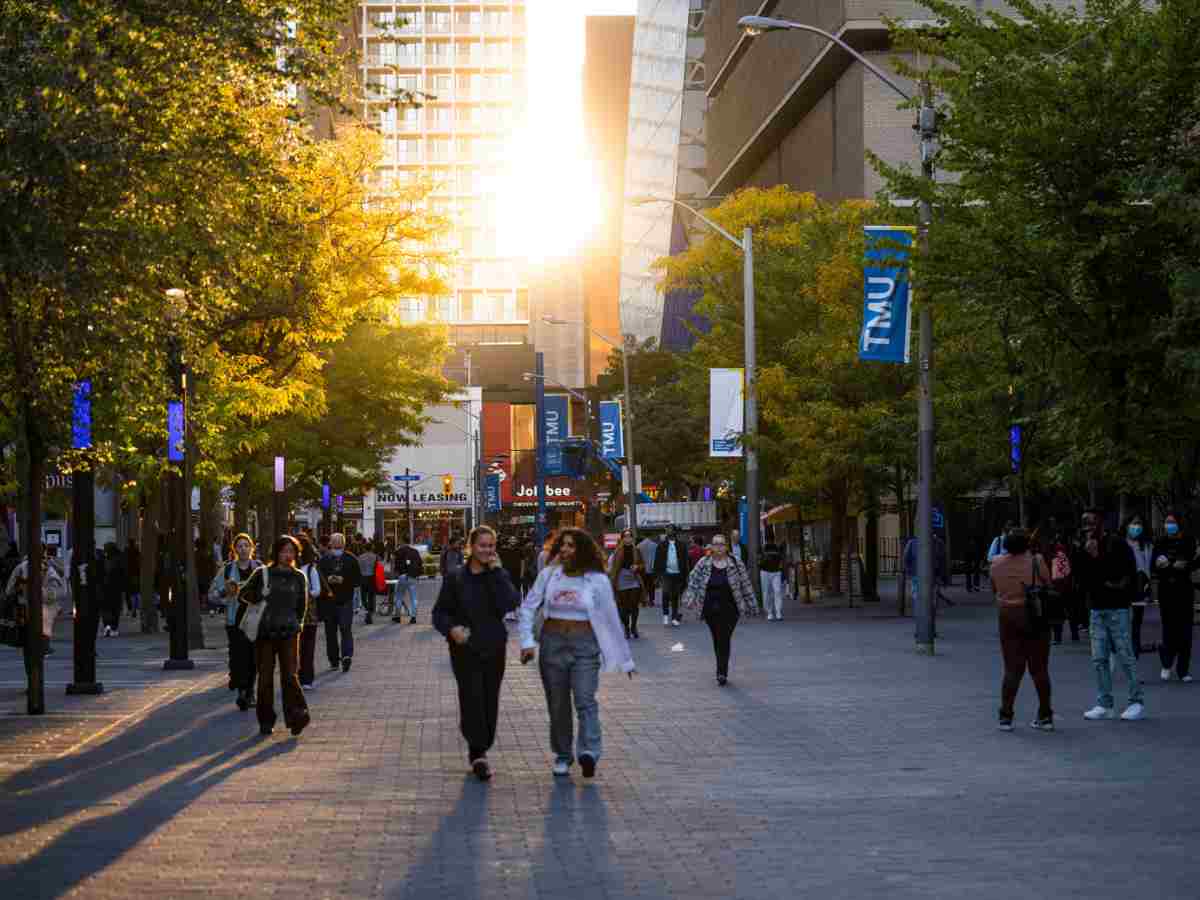 Students walking on Gould street at sunset.