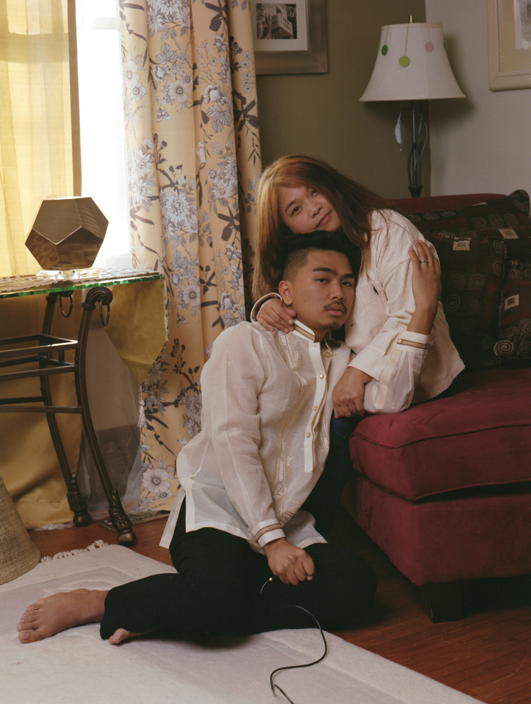 A couple embracing in a living room, example of student photography