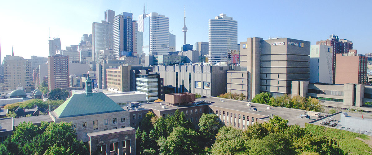Wide shot of Ryerson campus with Toronto skyline in the background on a sunny summer day.