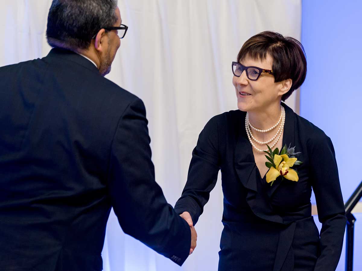 Mohamed Lachemi shaking hands with Cindy Blackstock