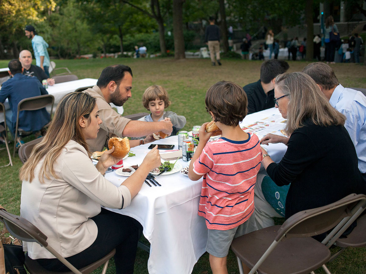 A family eating at a picnic table