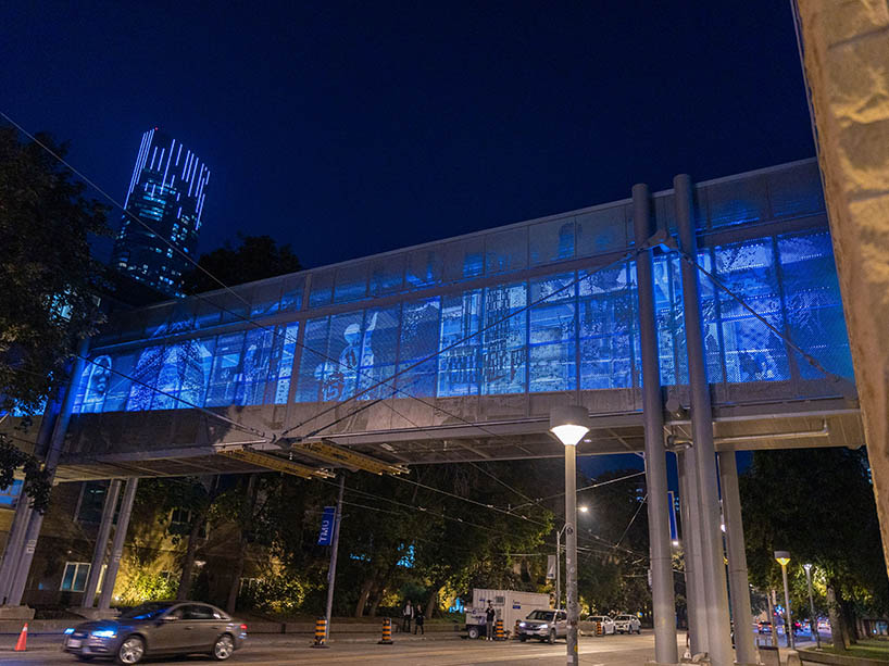 View of the Rogers Communications Centre (RCC) bridge lit up in the colour blue from the intersection of Church Street and Gould Street.