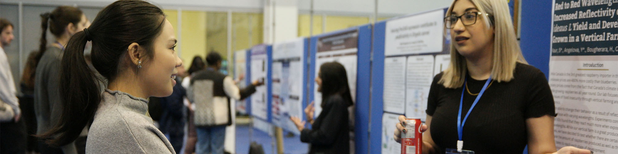 Undergraduate student presenting research at poster session at Ontario Biology Day