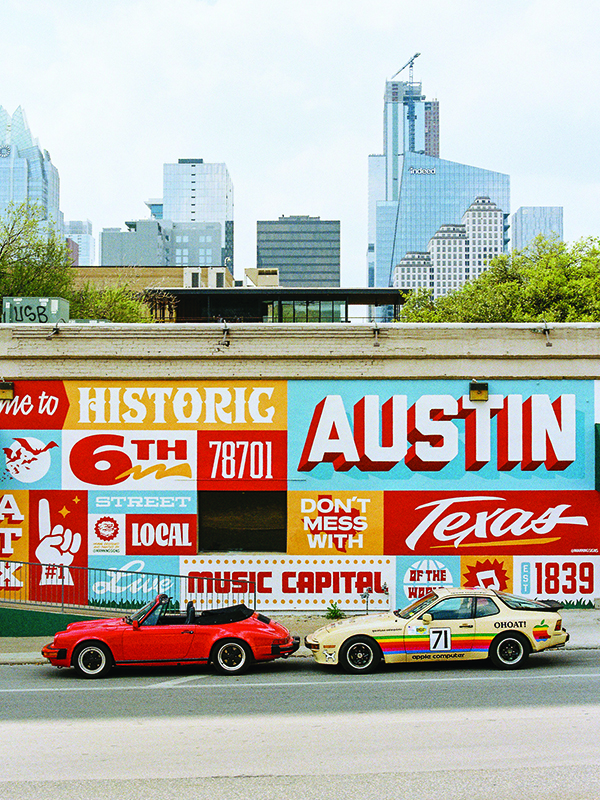 two cars in front of a colourful wall in texas