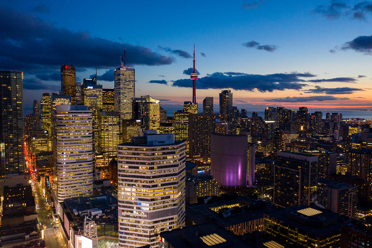 A nighttime skyline view of Toronto with the CN Tower visible