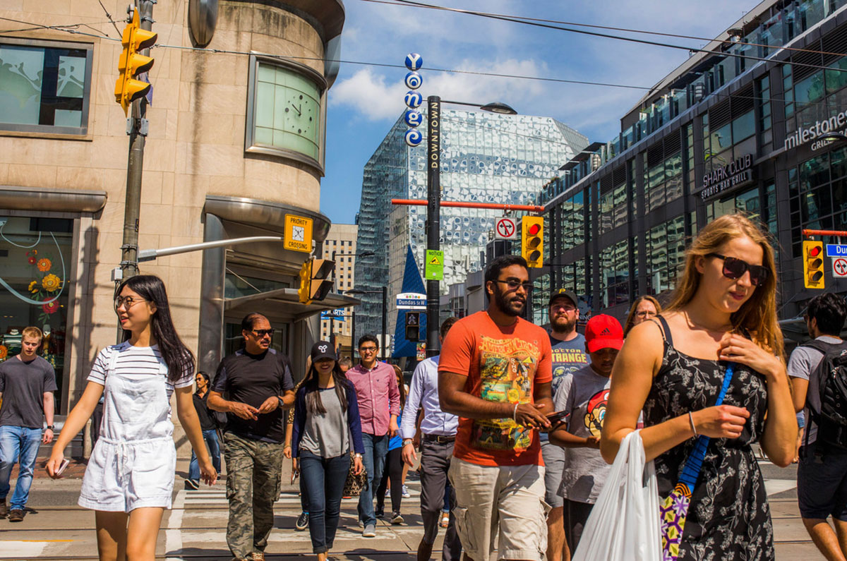 A crowd of people at the Yonge and Dundas crosswalk