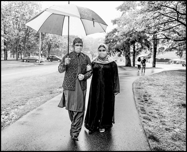 Couple takes a stroll in the rain wearing their masks in High Park in Toronto. Photo: George Pimentel, Image Arts ’92