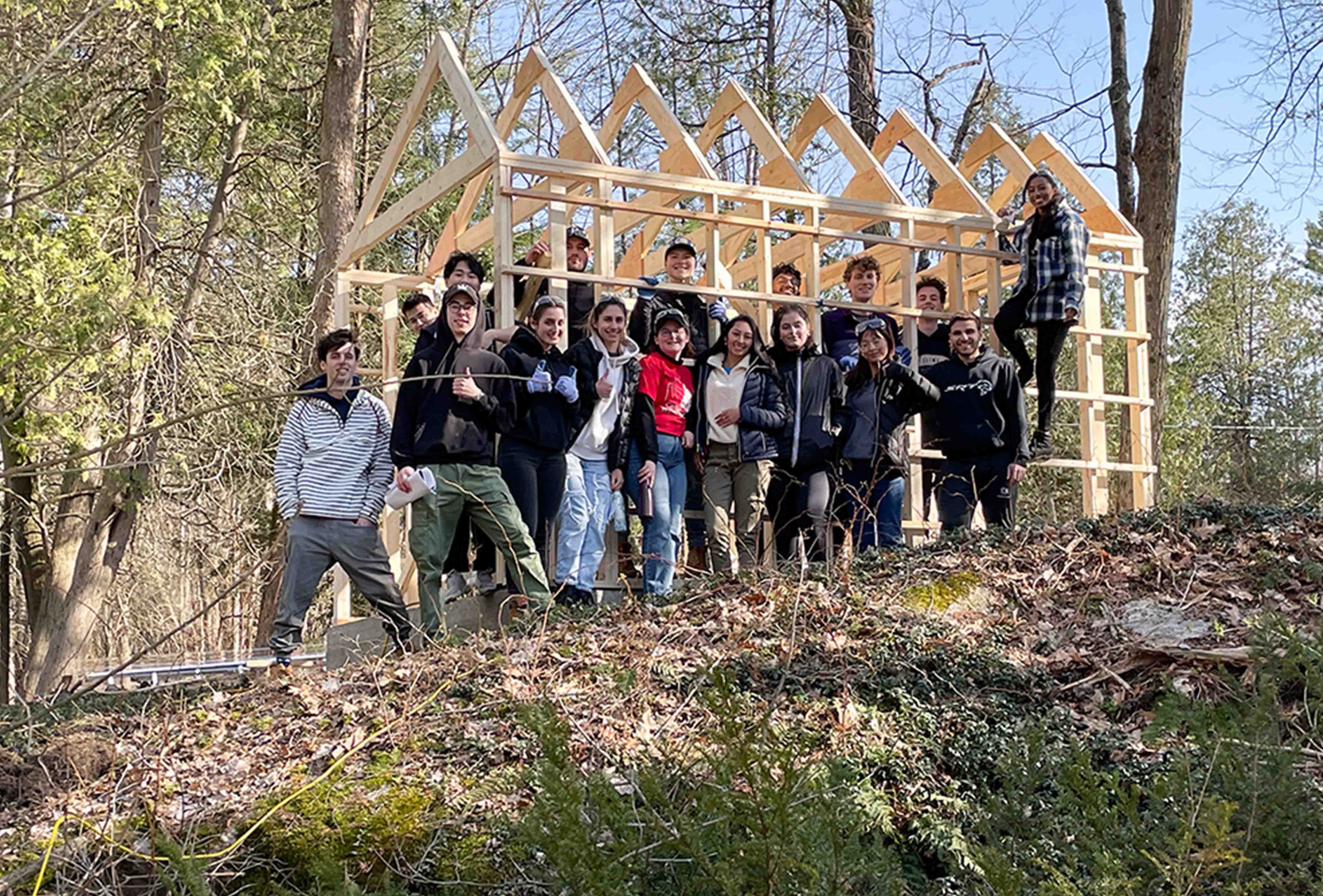 Students posing in-front of their Camp Winston design-build. 