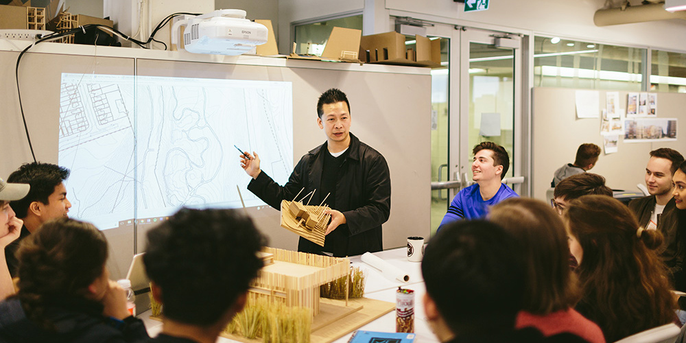 Vince Hui teaching in a classroom full of students