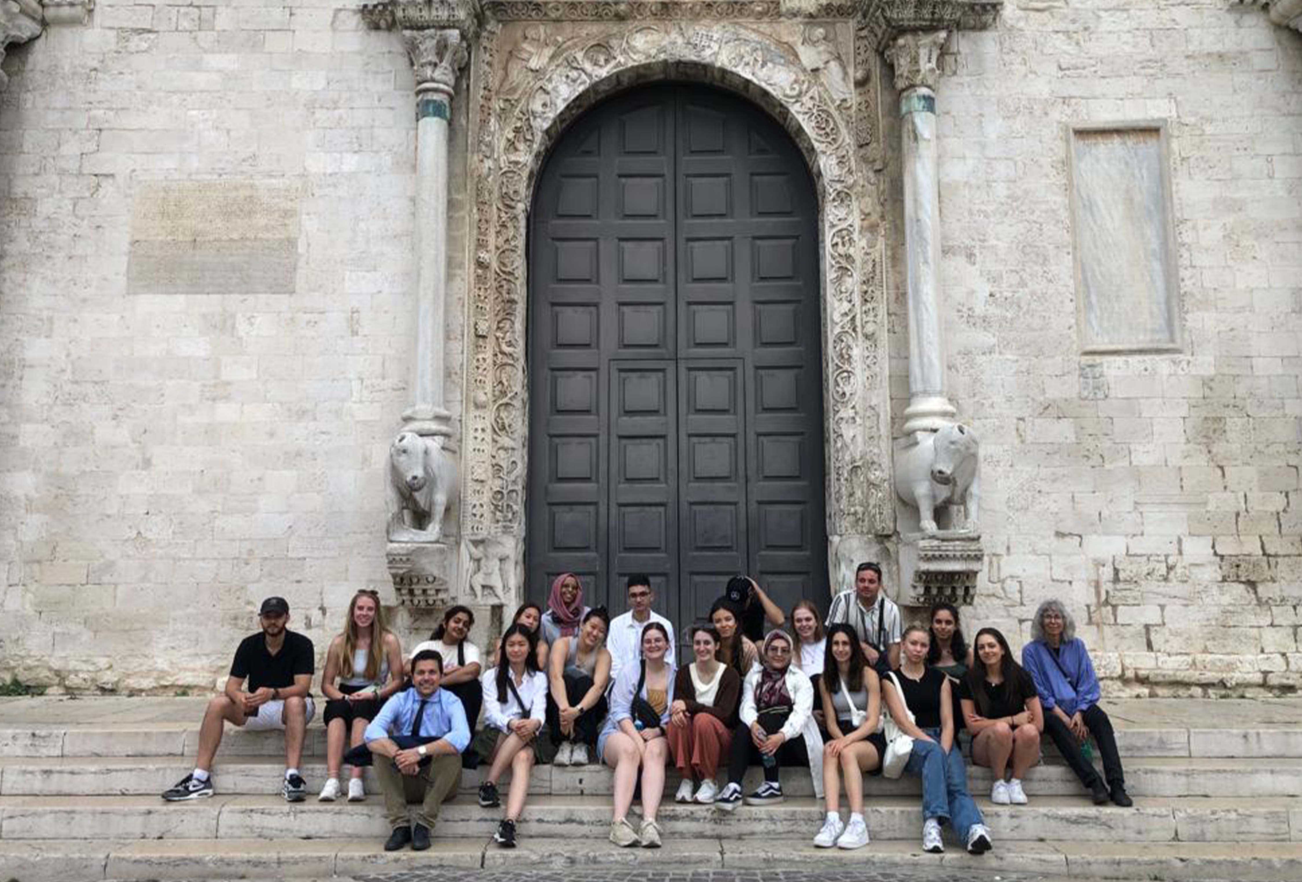 Students sitting on steps in Bari, Italy