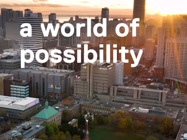 screenshot from a video showing drone shot of campus with overlay text a world of possibility