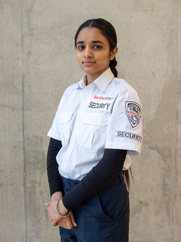 A staff member wearing the white extra coverage security guard uniform.