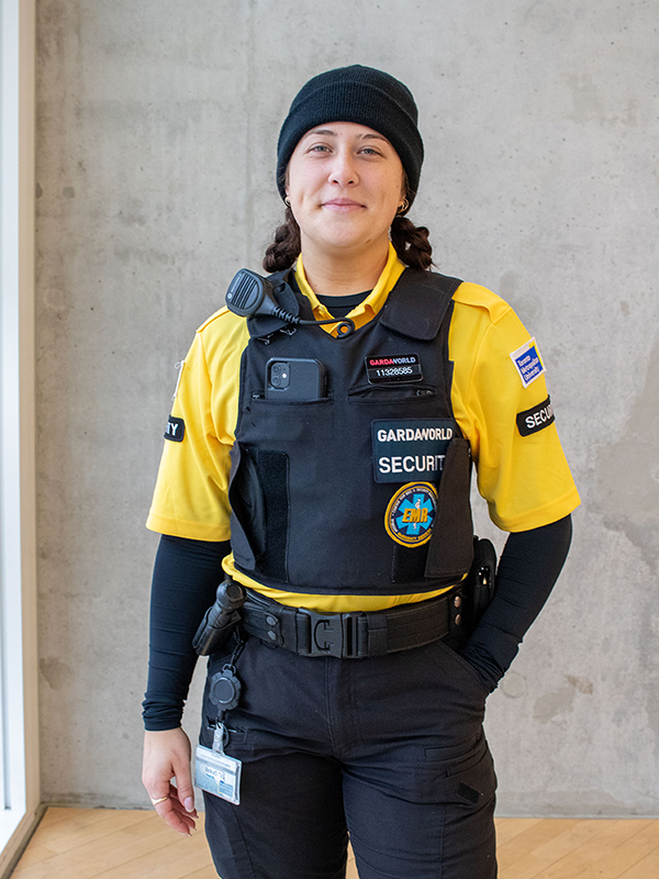 A staff member wearing the yellow full-time security guard uniform.