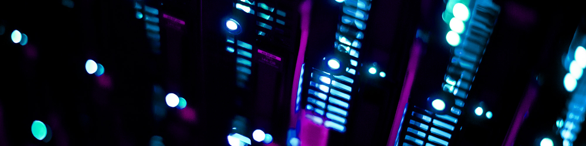 Closeup and blurred computer parts glowing in the dark.