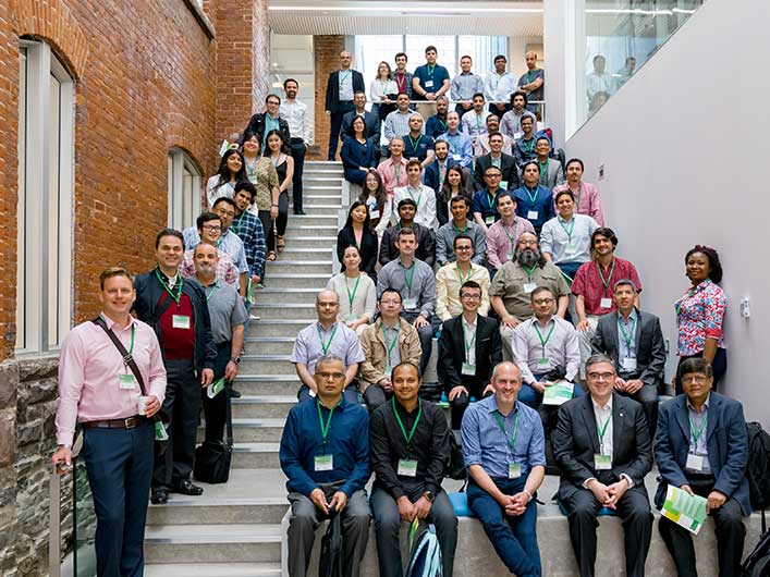 a large group of researchers on a staircase