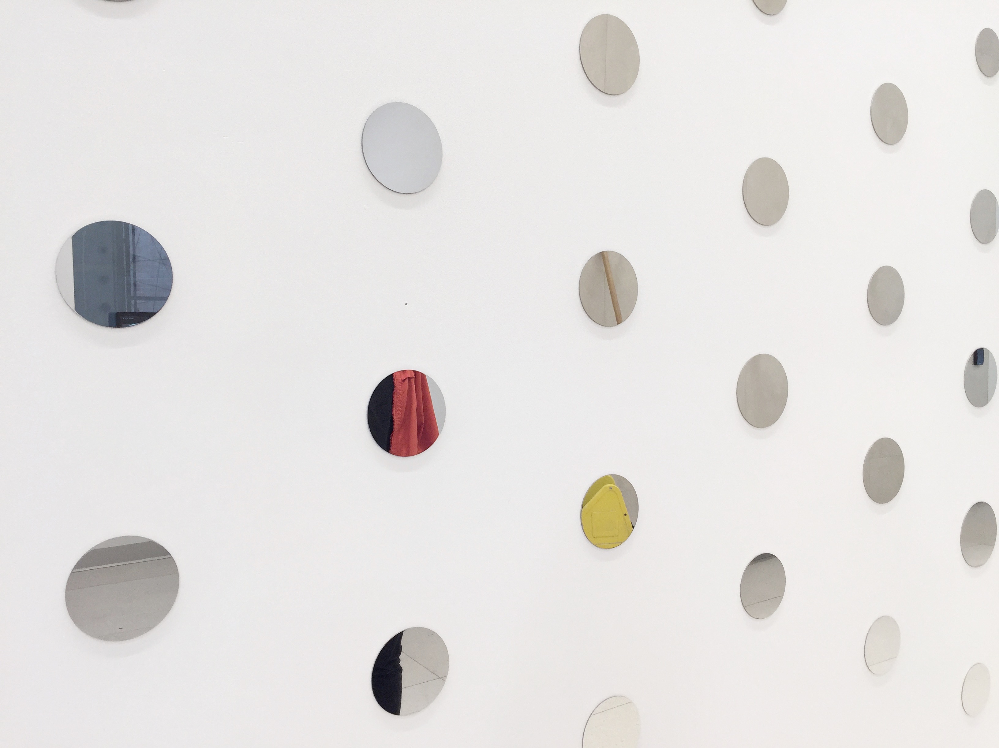 a white wall covered in printed circles.