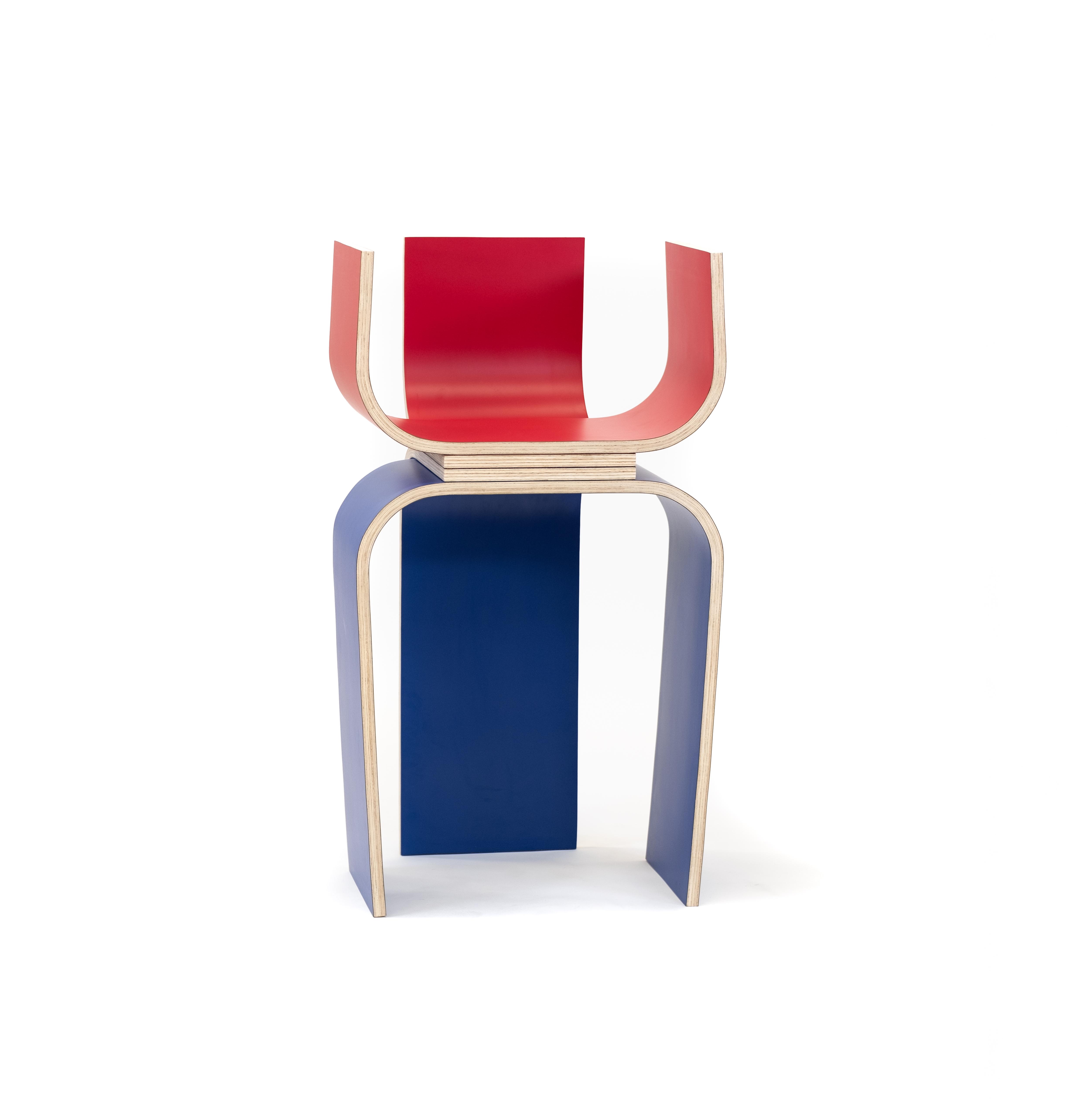 A funky chair made form colourful bent plywood. Red upper surface and blue lower surfaces.