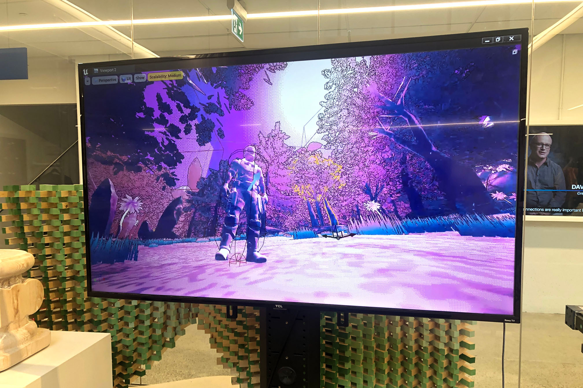 Picture of a screen showing a blue and purple virtual environment. There is a blobby character in the center of the screen. 