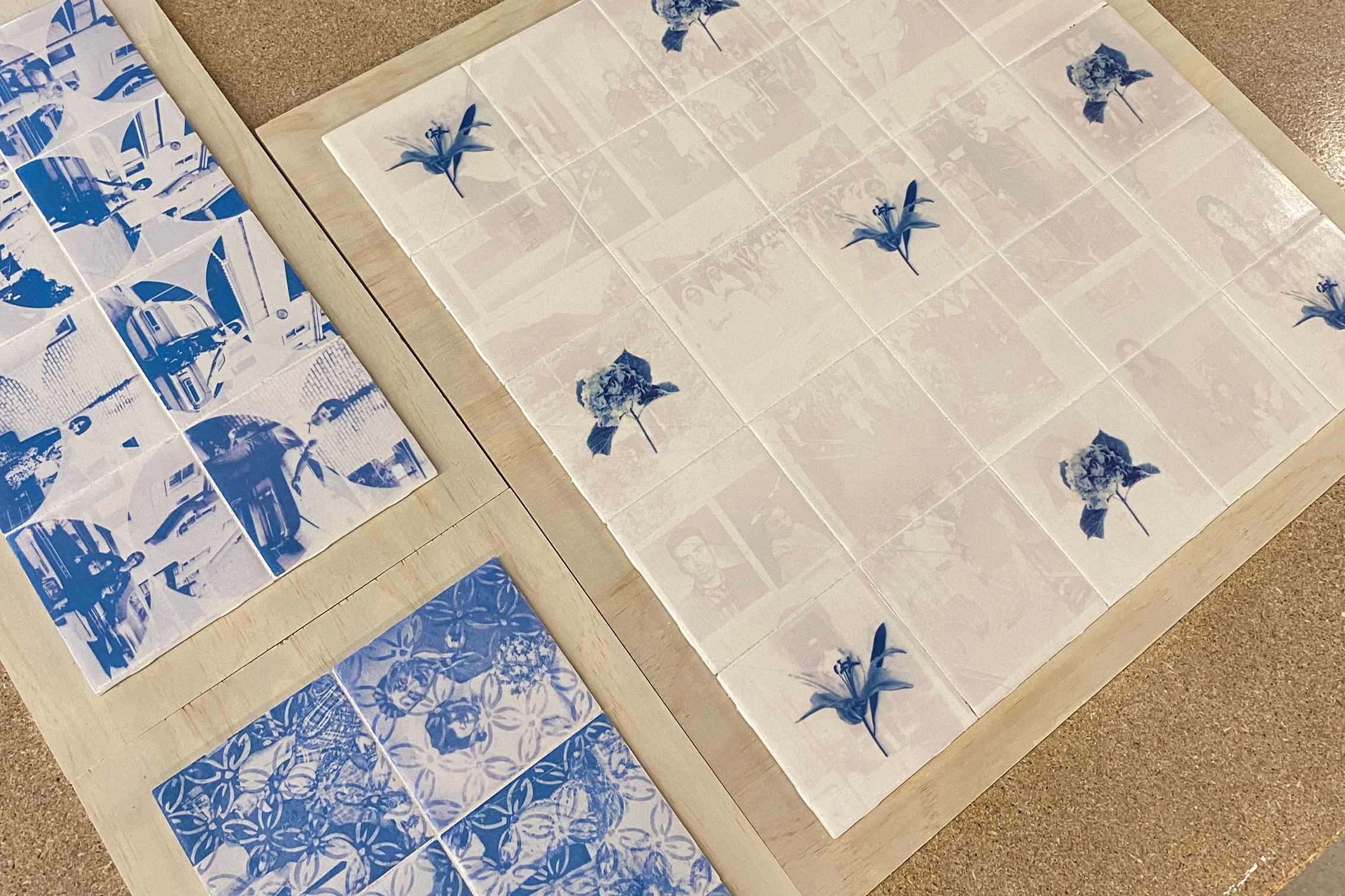 Blue and grey images printed on to translucent material, resembling blue-and-white pottery. 