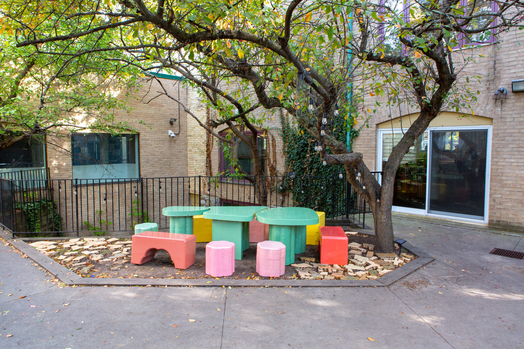 A select few colourful blocks from Cecil Community Planting Imagination project are neatly arranged in a courtyard on a sunny day.