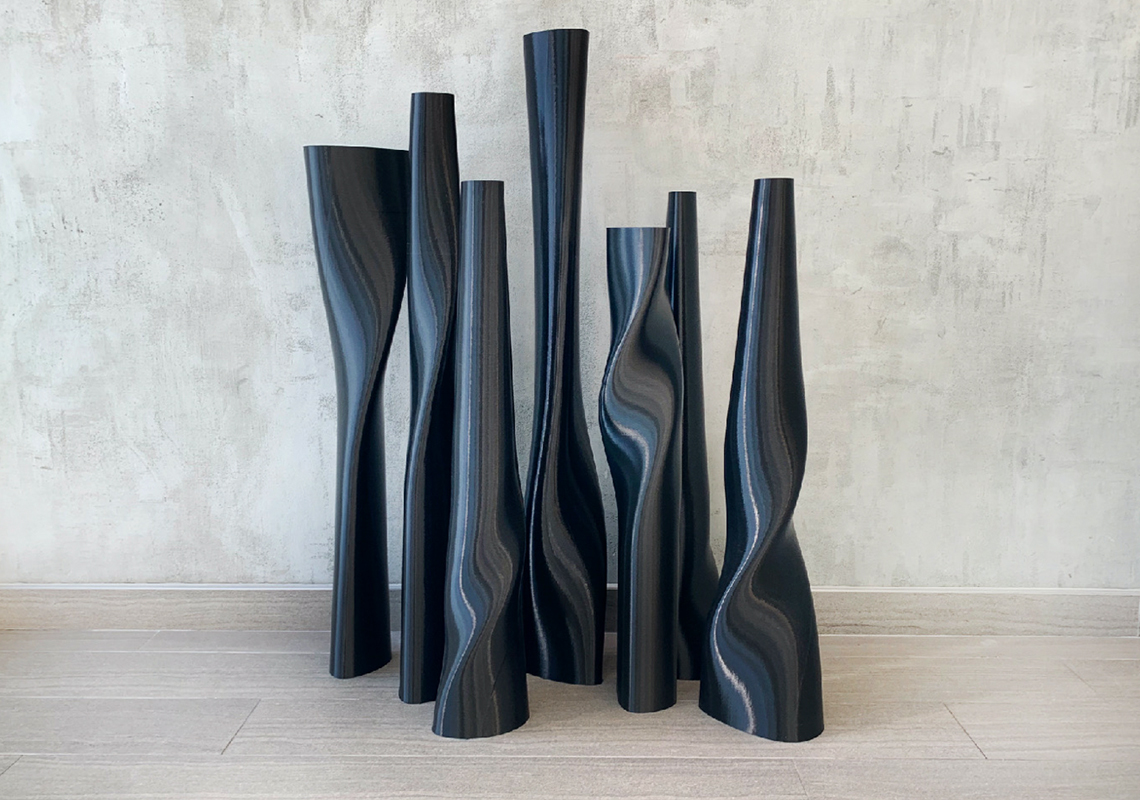 A collection of long and tall plastic vases, with varying heights and curvy profiles.