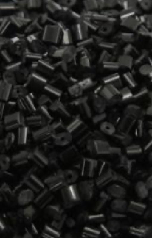 a close-up image of a collection of black plastic pellets..