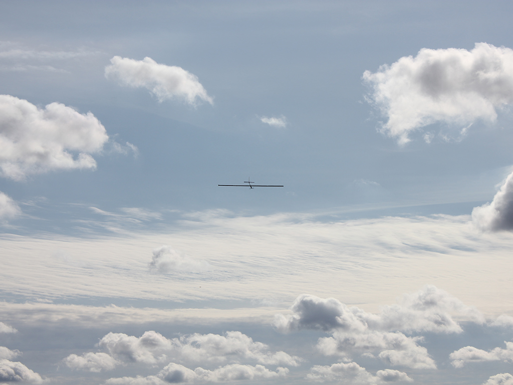 An aircraft in the sky above clouds