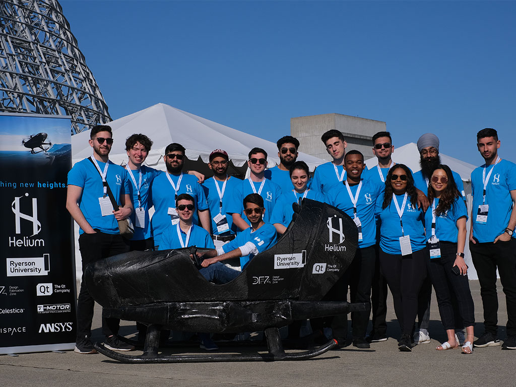 Members of Ryerson's Helium design team standing in front of their prototype of a personal flying vehicle.