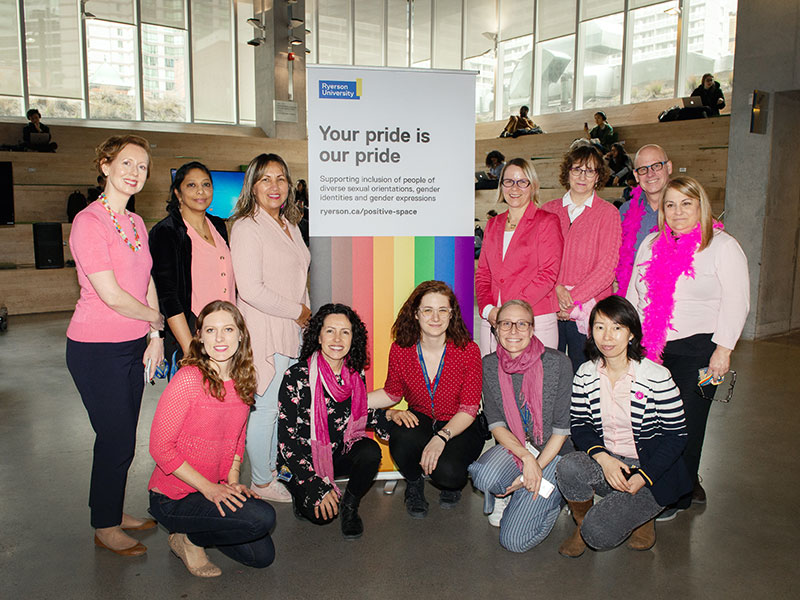 TMU staff members in pink shirts in the Student Learning Centre 