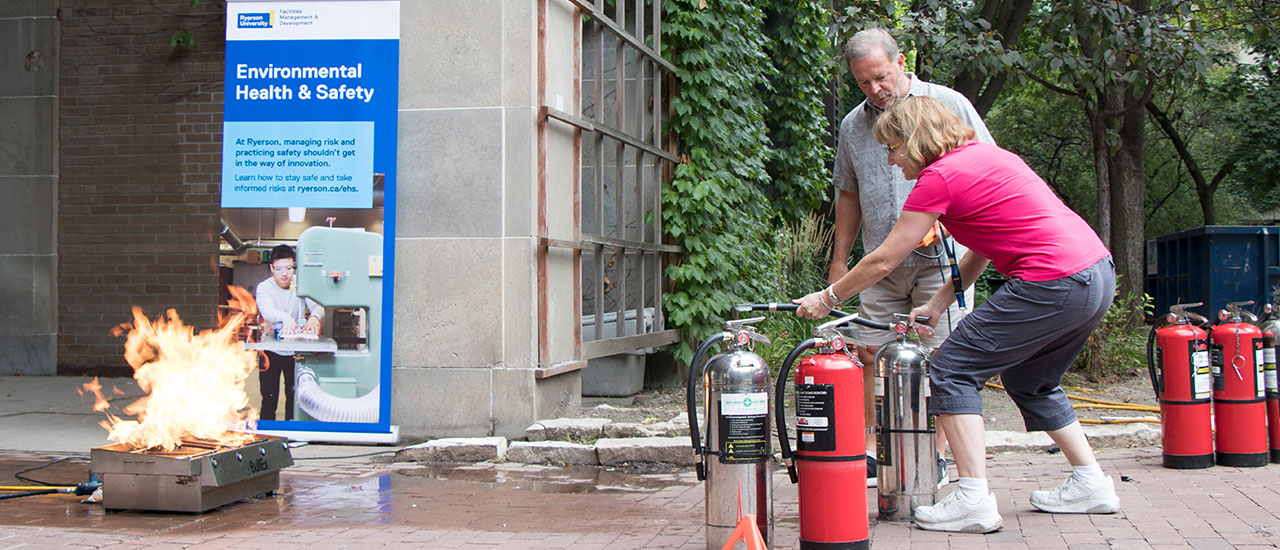 A Ryerson fire warden being trained how to put out a fire at the annual fire extinguisher training.