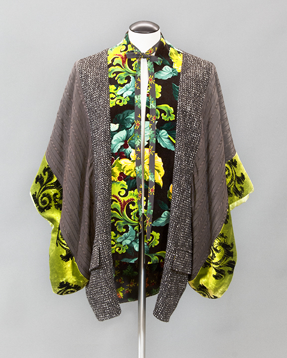 Mannequin wearing a green patterned kimono style jacket with decorative necktie