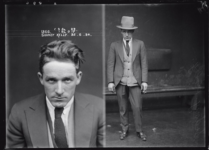 Black & white mugshot of Sidney Kelly in a suit looking at the camera & a full body photograph of him with a hat and holding a cigarette