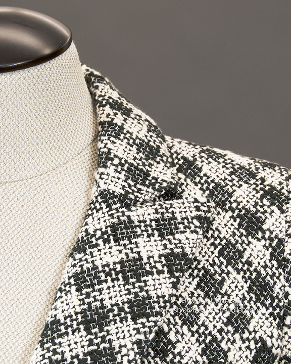 Collar detail of black and white woven blazer