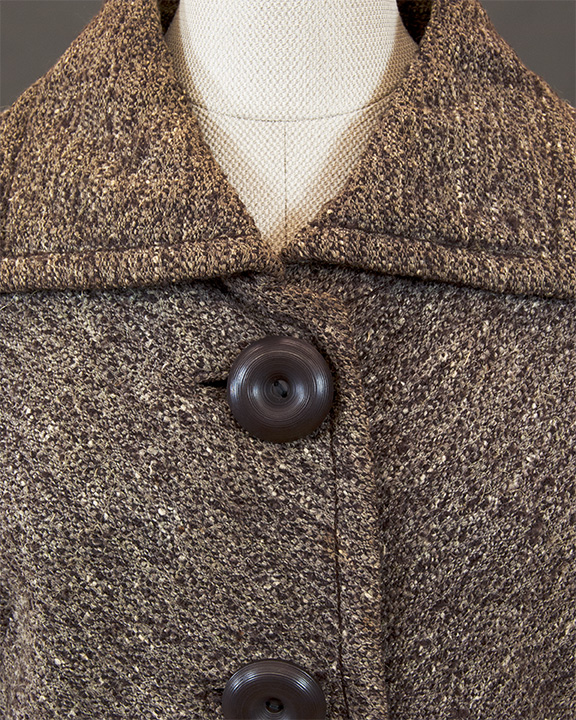 Button and closure detail on Christian Dior wool jacket