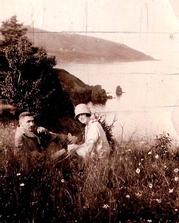 Old sepia photograph of Evelyn Wilkie and her husband sitting in a forest