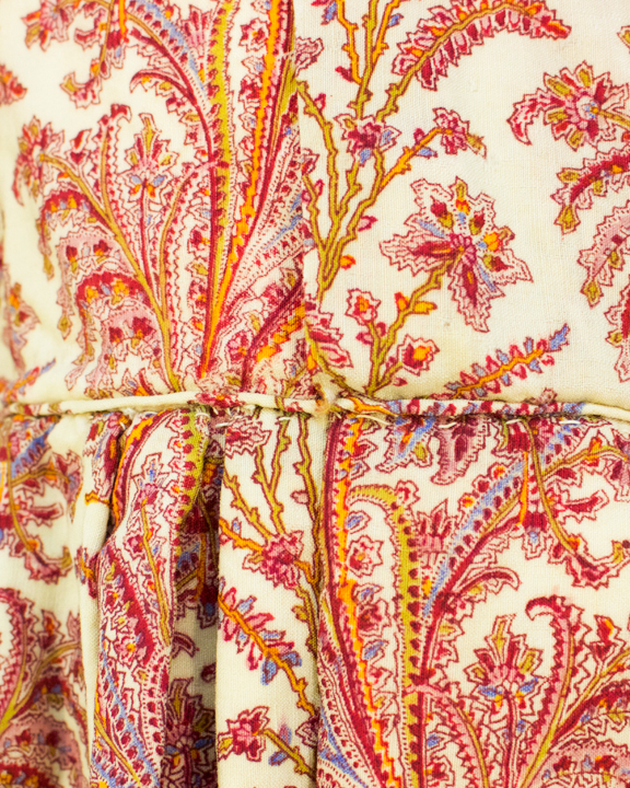 Close up of paisley pattern of a child's dress from the 1850s