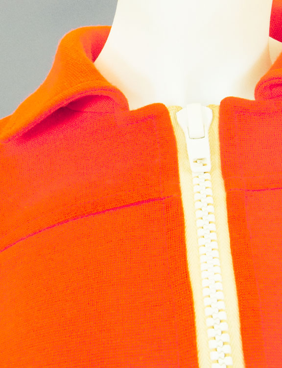 Collar and zipper of an orange Courreges jumpsuit