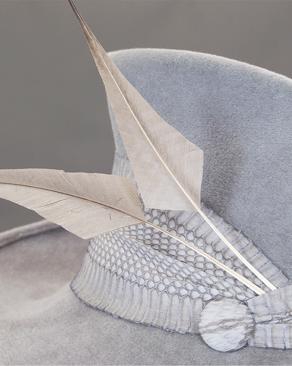 Close up of feather detail on grey fedora