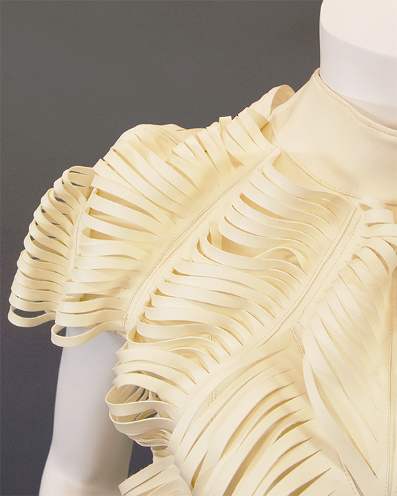 Close up of shoulder detail of Yvonne Lin's white slashed leather minidress