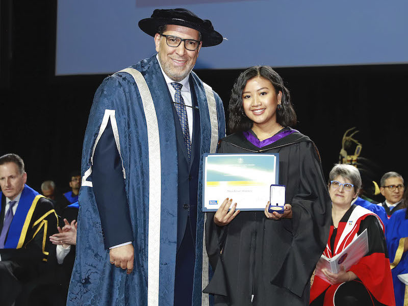 Maria Krisel Abulencia on convocation stage, receiving the Ryerson Gold Medal.