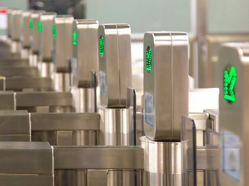 Presto machines lined up in a row at a subway station with green "go" light on