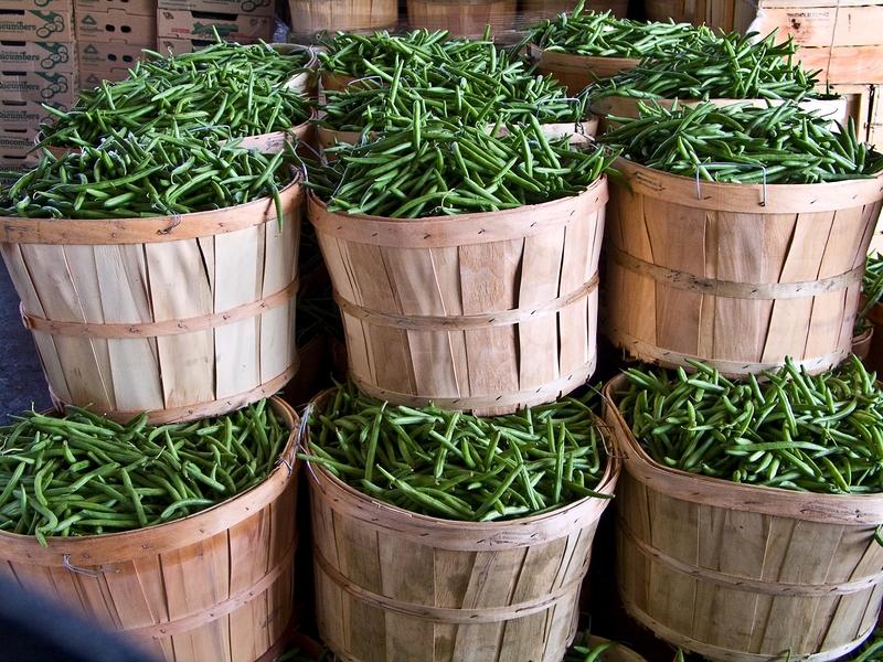 fresh market beans in stacked baskets