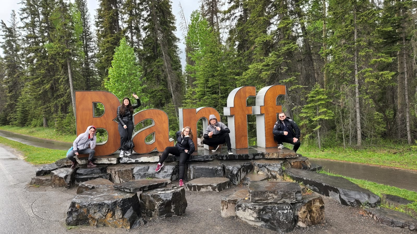 The Foucher Group standing in front of the Banff sign