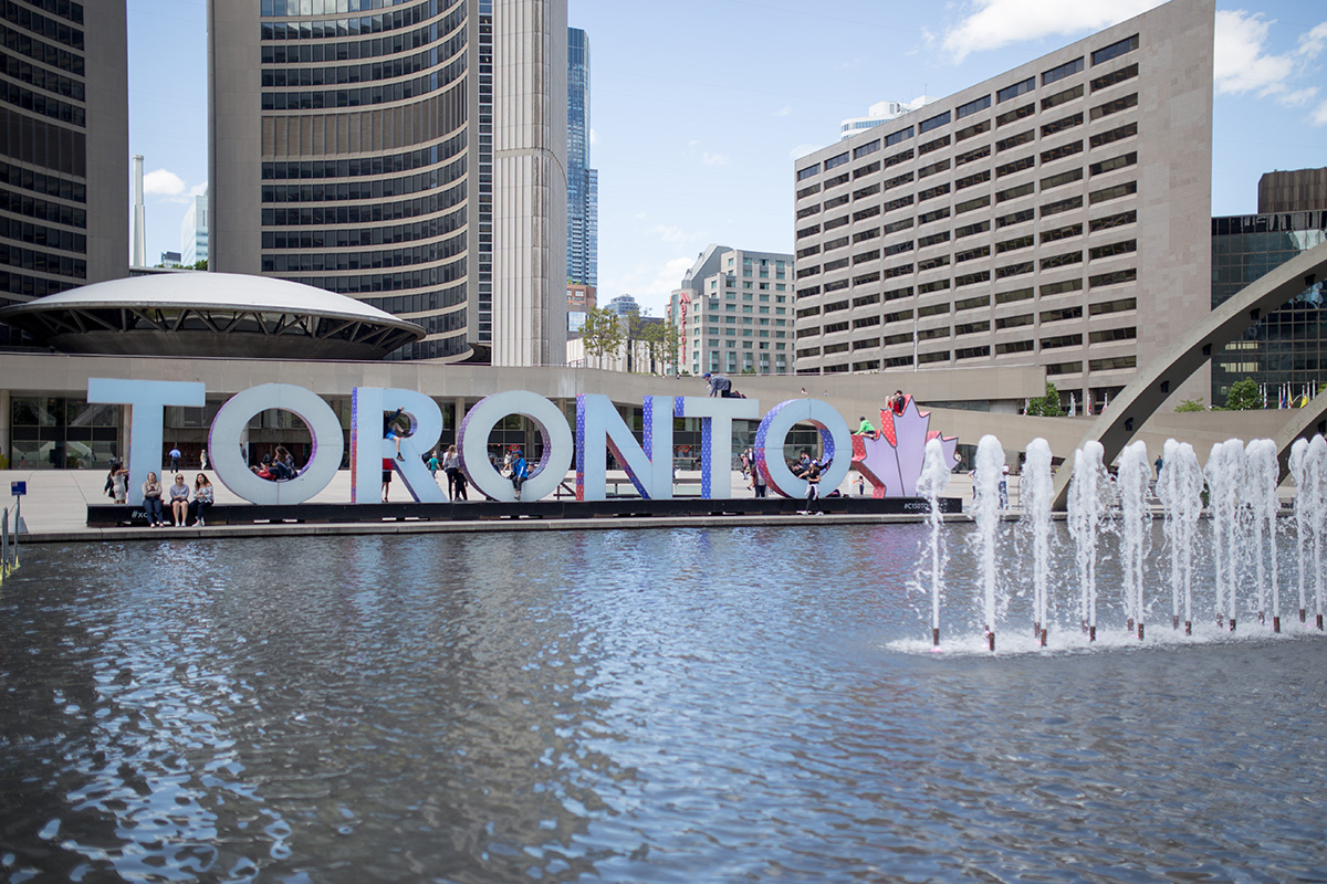 Toronto sign by fountain at Nathan Philips Square.